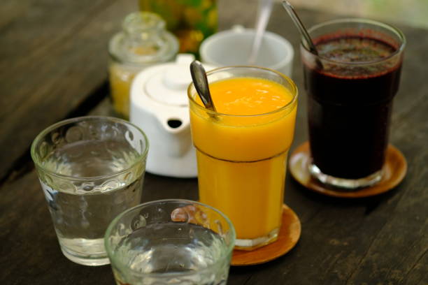 istock refreshing cold drinks. Mango juice, mulberry juice, water on a brown wooden table. refreshment drink. jus buah. assortment of juice. 1480737113
