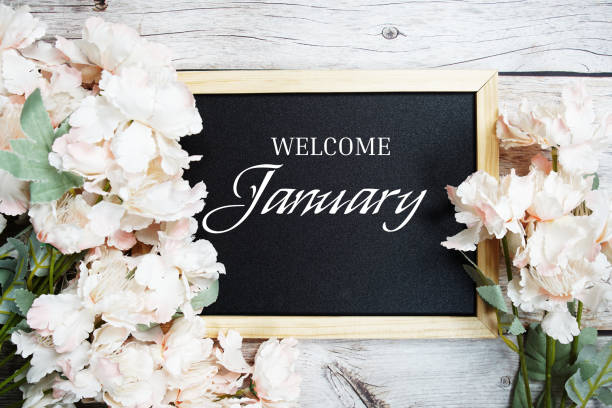istock Welcome January text message on blackboard with flower decoration on wooden background 1480740164