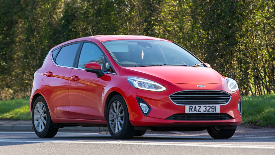 Bicester,Oxon, UK - April 7th 2023.2020 red FORD FIESTA TITANIUM TURBO MHEV car travelling on an English country road