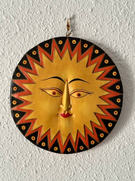 istock Decorative figure in the shape of a smiling sun hanging on a white wall 1480742011