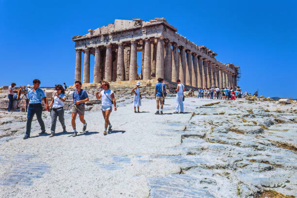 Athens, Greece - March 13, 2024: Amidst scaffolding and bustling activity, the Parthenon, an enduring symbol of classical architecture, undergoes meticulous restoration. Skilled craftsmen and engineers work tirelessly to preserve the magnificence of this ancient marvel, carefully repairing weathered marble and reinforcing delicate columns. Despite the construction, the timeless elegance of the Parthenon still shines through, its majestic silhouette standing as a testament to the ingenuity and resilience of ancient civilizations. As visitors observe the ongoing restoration efforts, they are reminded of the enduring legacy and cultural significance of this iconic monument.