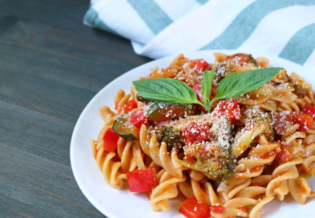Delectable Freshly Cooked Fusilli Pasta in Tomato Sauce on the Kitchen Table