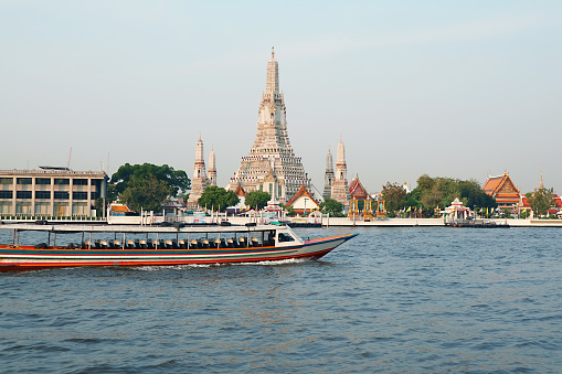 The Iconic Temple of Dawn or Wat Arun with the Famous Chao Phraya River Water Bus in Foreground, Bangkok, Thailand
