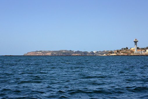 Dakar, Senegal: Cape Manuel, located at the southern tip of the Cap-Vert peninsula . It owes its name to Dim Manuel I, King of Portugal (1495-1521). This basaltic headland offers protection to the port of Dakar. It is also a residential area where there are several embassies, including the French Embassy, as well as the residence of the European Union - on the right, the harbor control tower at Dakar Point.