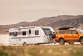 Pickup truck pulling a trailer on country road near the lake, Anatolia, Turkiye