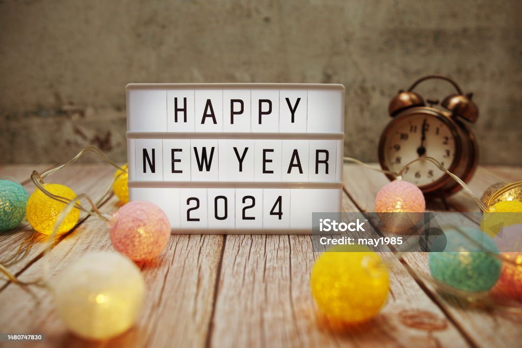 Happy New Year 2024 text on lightbox on wooden background 2024 Stock Photo