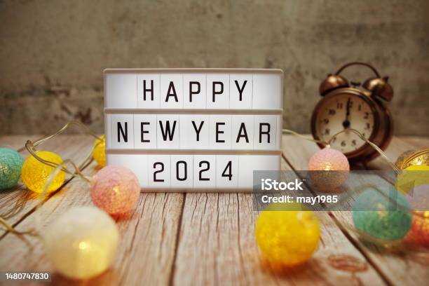 Happy New Year 2024 Text On Lightbox On Wooden Background Stock Photo - Download Image Now