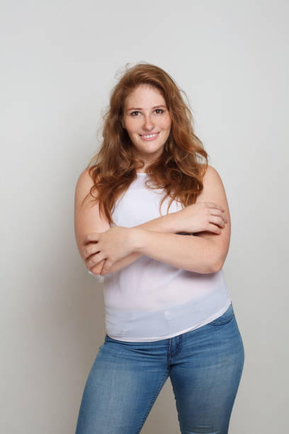 Happy attractive curvy woman standing on white