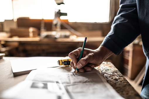 Close-up of a man drawing a project on work