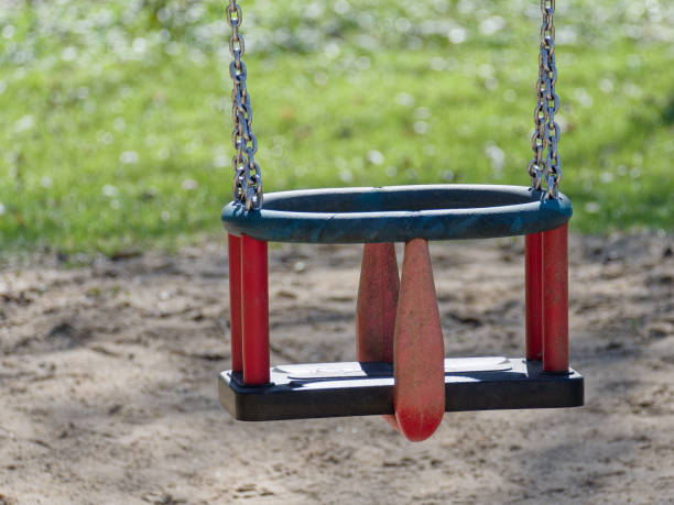 istock Children's swing on chains in a public park. 1480753184