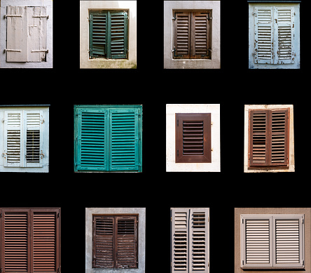 Mediterranean style house windows covered by exterior shutters set front view isolated on black