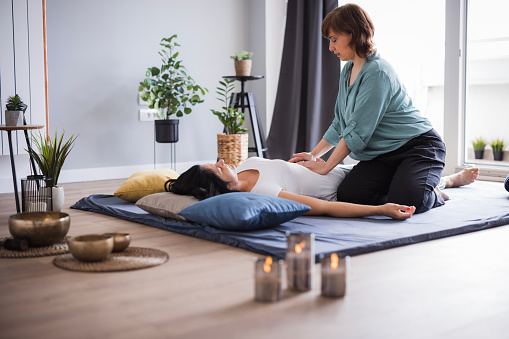 Woman resting when having a Shiatsu masseuse massage and pressure her stomach