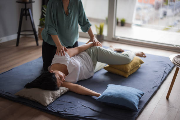 istock Woman lying on side and having one side of her upper body stretched 1480754323