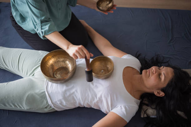 istock Young woman experiencing Tibetan singing bowl massage 1480755046