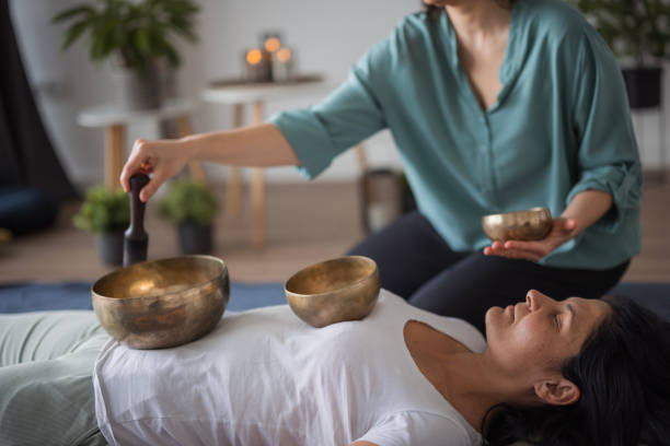 istock Woman lying on back during Tibetan singing bowls deep meditation and message 1480755065