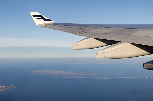 Saltholm, Denmark - February 8th 2023:  View over Øresund / The Sound to the islands Saltholm and Peberholm. The last marks the beginning of the bridge between Denmark and Sweden - it is connected to Denmark through a tunnel. It is seen under the wing of an Airbus 330-300 from Finnair during taking off from Copenhagen Airport