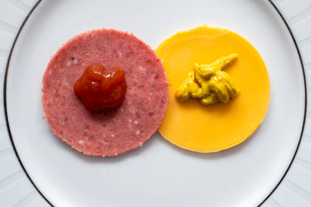 Hot dog with ketchup on a white plate. Close up.