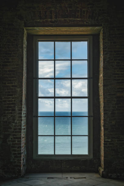 Nothern Ireland - Mussenden Tempel Looking through a window at the Atlantic Ocean at Mussenden Temple- purpur stock pictures, royalty-free photos & images