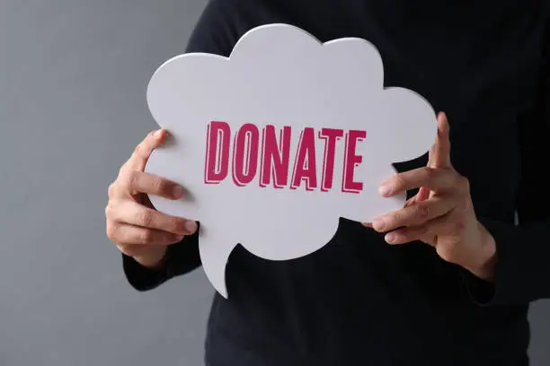 Photo of Woman showing Donate on speech bubble