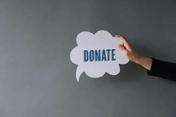 Photo of Woman showing Donate on speech bubble