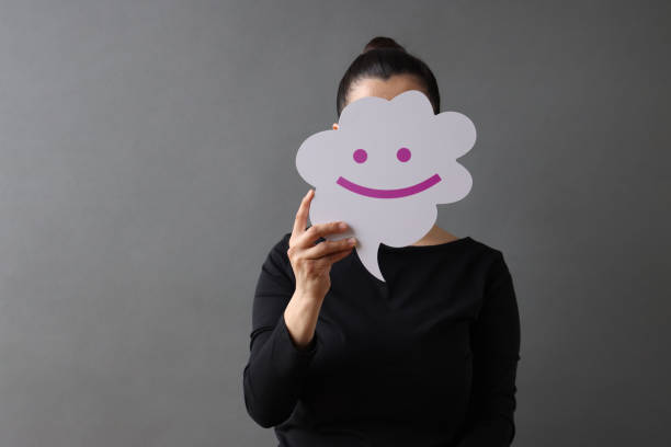 istock Woman holding speech bubble with smile emoji 1480774699