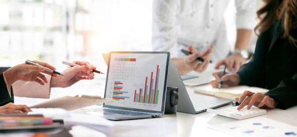 istock diverse coworkers working together in boardroom, brainstorming, discussing and analyzing and planning business strategy. 1480775251