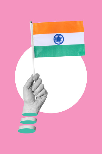Art collage, Hand with Indian flag on pink background. Concept of enlightened Indian economy and patriotism.