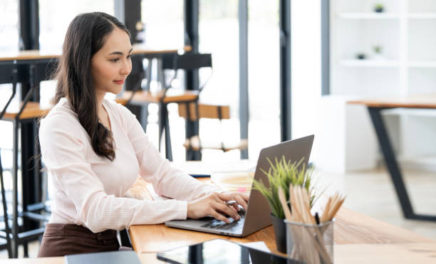 istock Young asian woman working on laptop computer at co-workspace. 1480777689