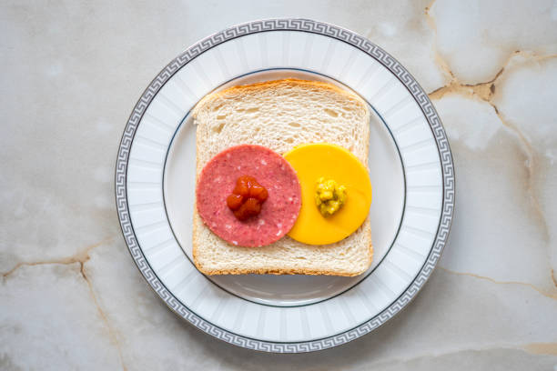 An open ham and cheese sandwich - white background