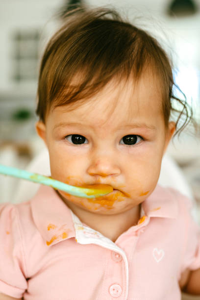 istock Messy Baby Girl Eating By Her Self 1480786711