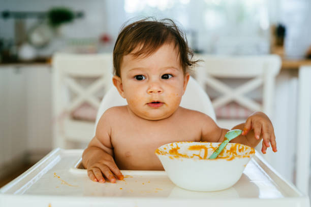 istock Messy Baby Girl Eating By Her Self 1480787287