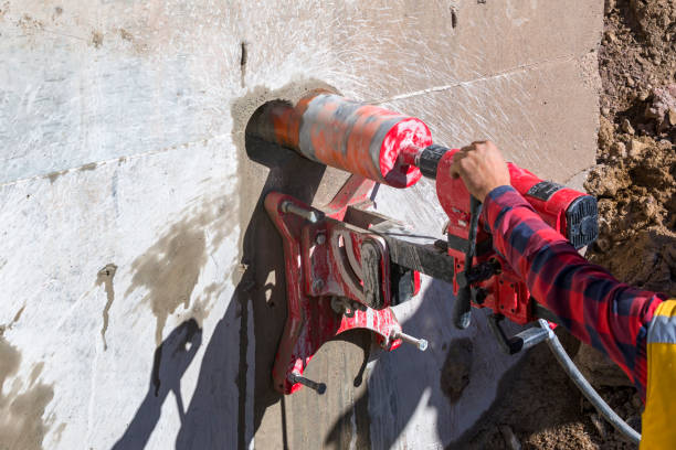 istock Worker is drilling to concrete wall with core drill machine. Core drills used in metal are called annular cutters. Core drills used for concrete and hard rock generally use industrial diamond grit. 1480787984