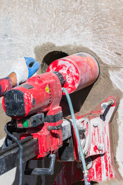 istock Worker is drilling to concrete wall with core drill machine. Core drills used in metal are called annular cutters. Core drills used for concrete and hard rock generally use industrial diamond grit. 1480788021