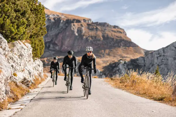 Photo of Professional Cyclists Riding Through Nature