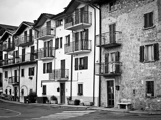 Row houses facades in a mountain village. Black and white image.