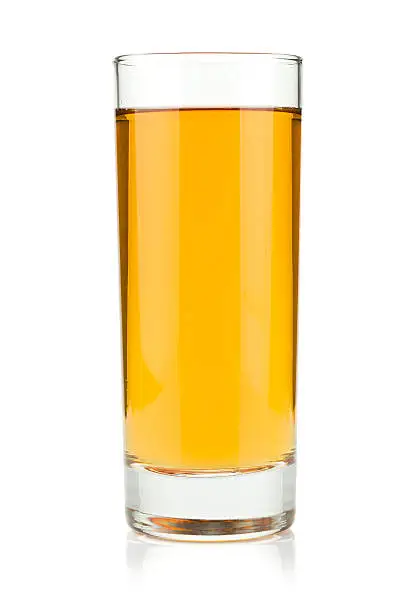 Apple juice in a glass. Isolated on white background