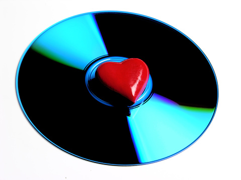 High angle view of compact disc with heart shape at its center