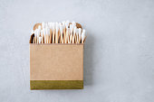 Bamboo ear sticks. Eco-friendly cotton swabs on gray background, top view, copy space.