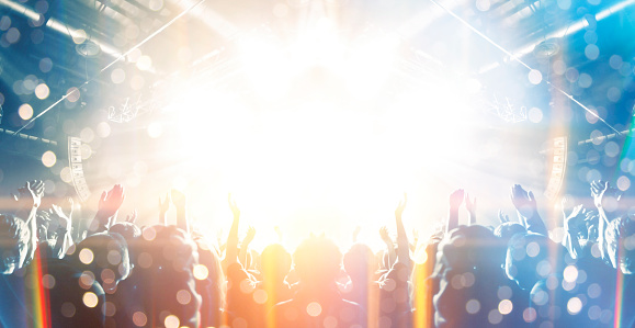 Concert photography during a gig,this is the point of view of the crowd in front of a stage during a music festival