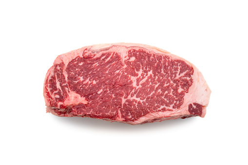 Raw USDA prime beef loin New York Strip steak isolated on white background.