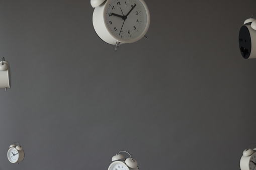 Group of alarm clocks on gray background