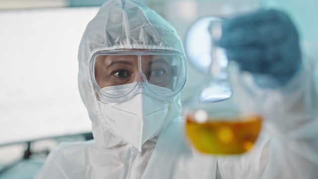 Bottle, liquid and chemical, scientist in ppe and science experiment, person in laboratory and chemistry. Medical research, pharmacy and doctor stirring oil in container closeup and scientific study