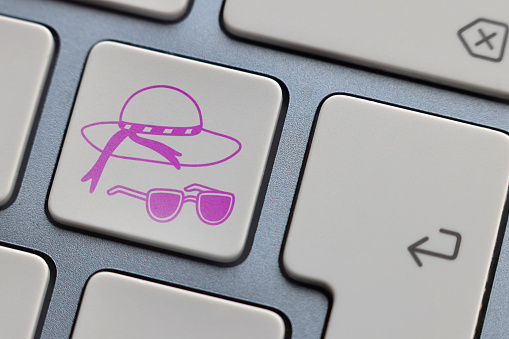 Hat and sunglasses icon on keyboard
