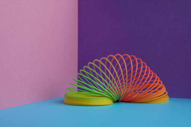 Closeup of rainbow spring toy and rings in soft light. High quality photo