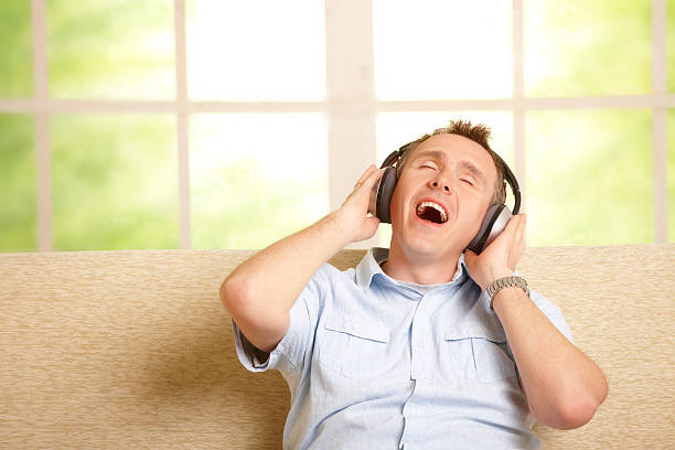 istock Man listening music and singing 148081787