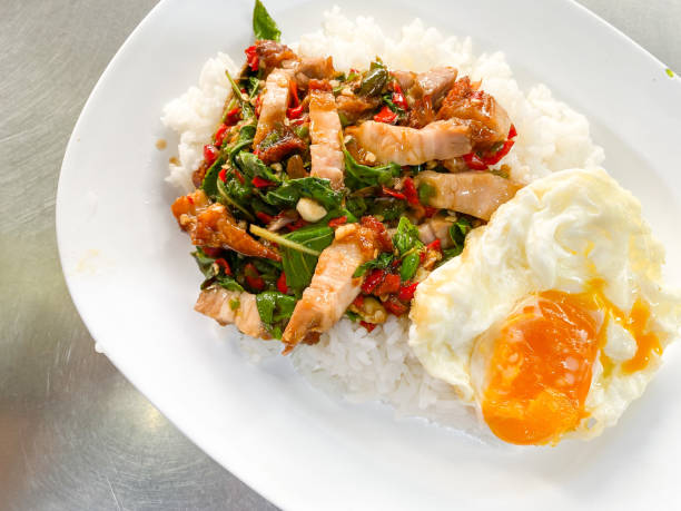istock Rice topped with crispy pork belly with Thai basil and fried egg 1480824686