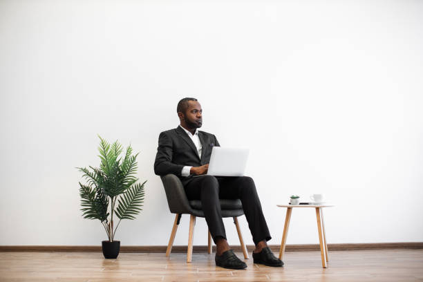 istock Focused african man working on laptop at office 1480826247