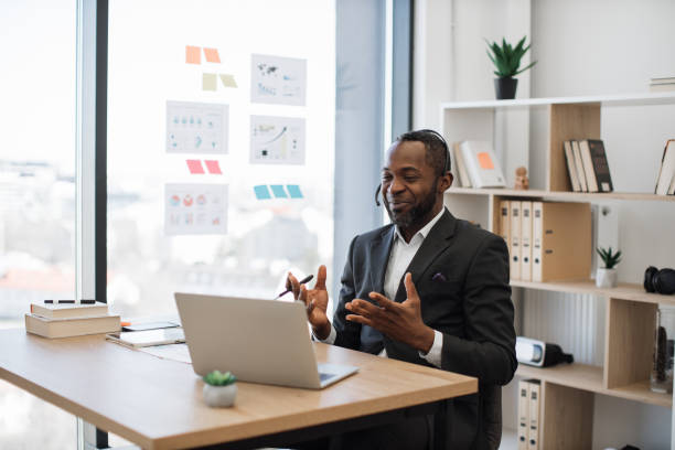 istock African businessman in headset using laptop for videochat 1480826296