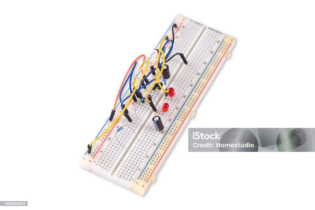 Breadboard with electrical elements, on white background. Bread Stock Photo