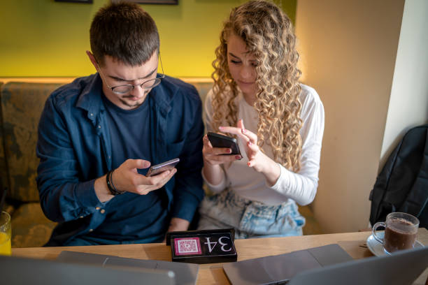 istock People at a restaurant scanning the menu with QR codes 1480828166